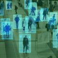 Overhead, ‘security camera-style’ shot of people walking in a building complex; each person is outlined by a blue box.